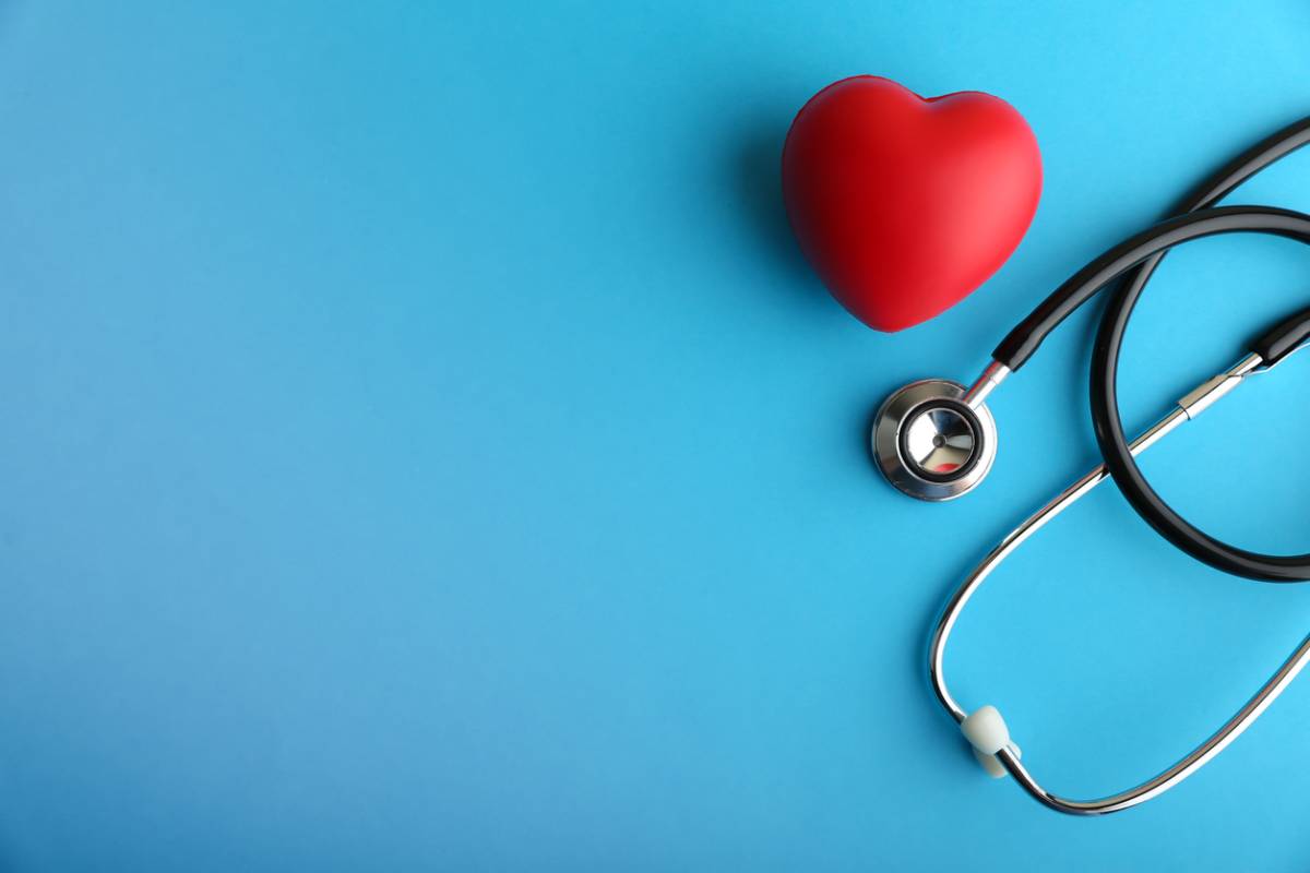 Stock image of decorative heart and stethoscope on blue background