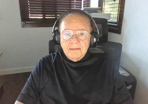Picture of Dr gura with headphones before a computer