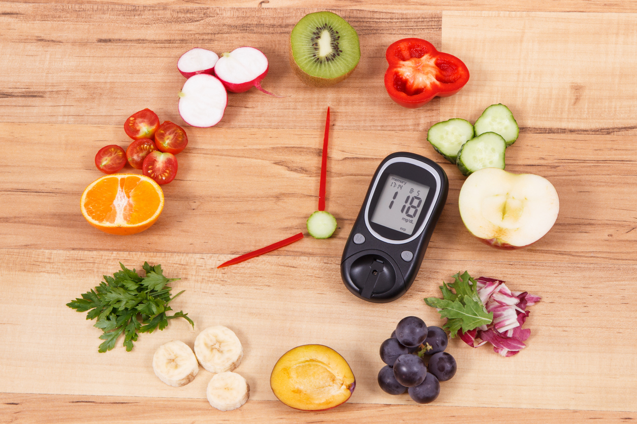 Glucose meter with fruits and vegetables in shape of clock, healthy eating for breakfast concept