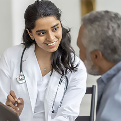 Stock image of a smiling lady doctor explaining something to her patient