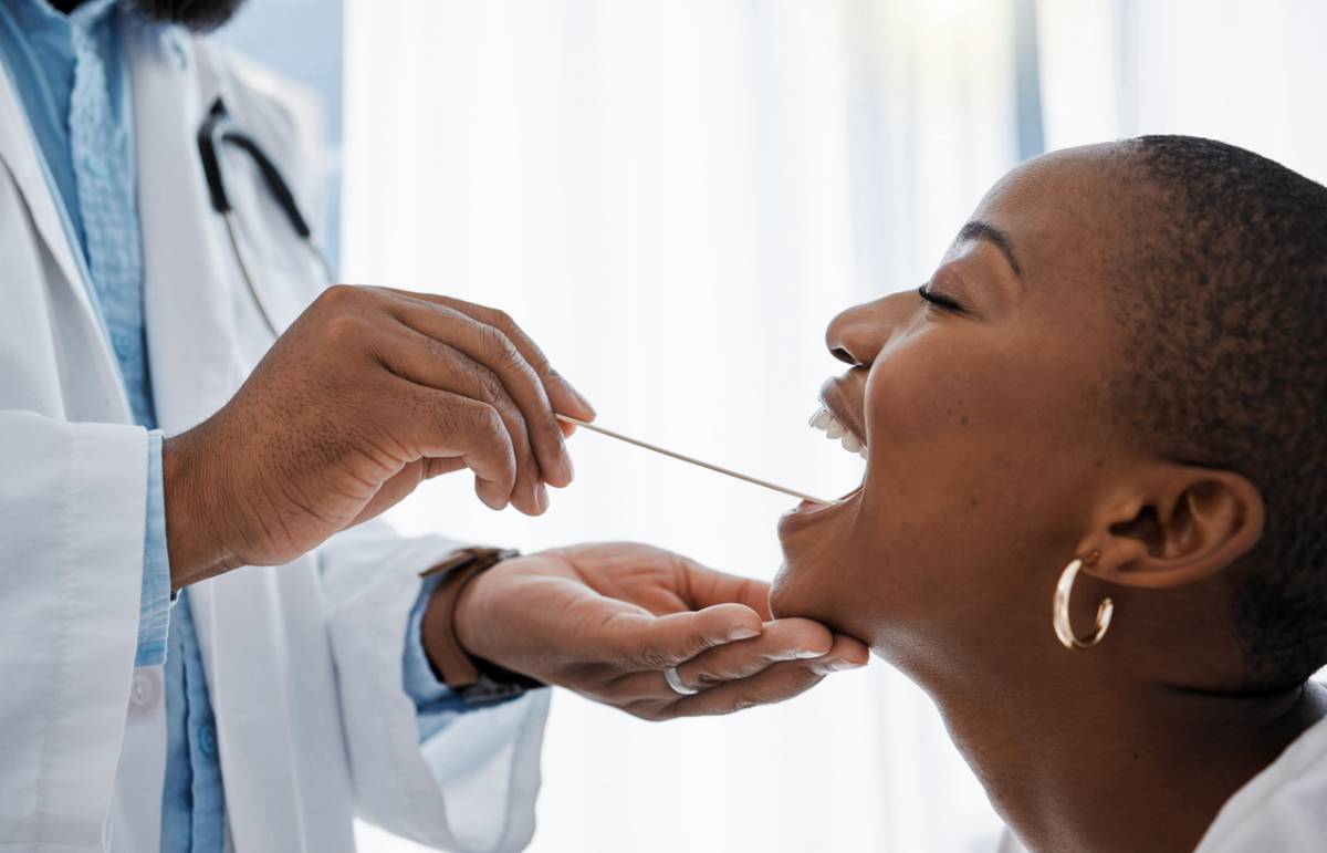Picture of doctor checking his patient's tongue
