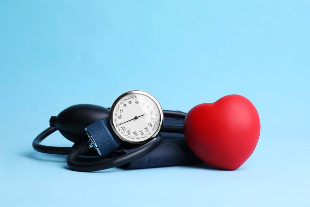 Blood pressure checking apparatus with a love symbol balloon beside it stock image